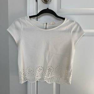 Cropped white blouse with floral cut-outs
